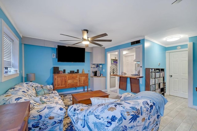 living room with ceiling fan, light wood-type flooring, and crown molding