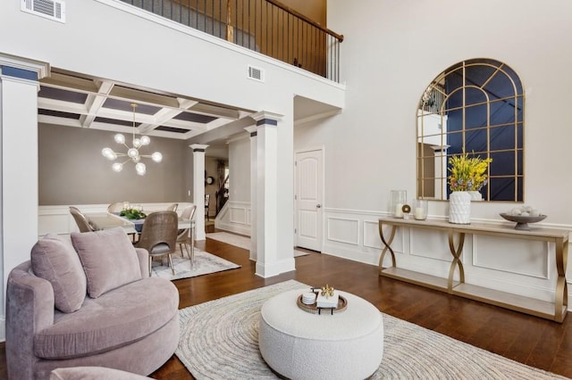 6977 Demeter Dr, Atlanta, GA 30349 - living area with ornate columns, coffered ceiling, wood-type flooring, a chandelier, and beam ceiling