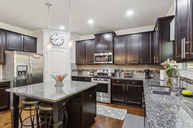 6977 Demeter Dr, Atlanta, GA 30349 - kitchen with appliances with stainless steel finishes, a sink, dark brown cabinets, tasteful backsplash, and stone counters