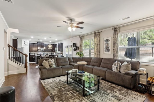 6977 Demeter Dr, Atlanta, GA 30349 - living room featuring ornamental molding, ceiling fan, stairs, dark wood-type flooring, and recessed lighting