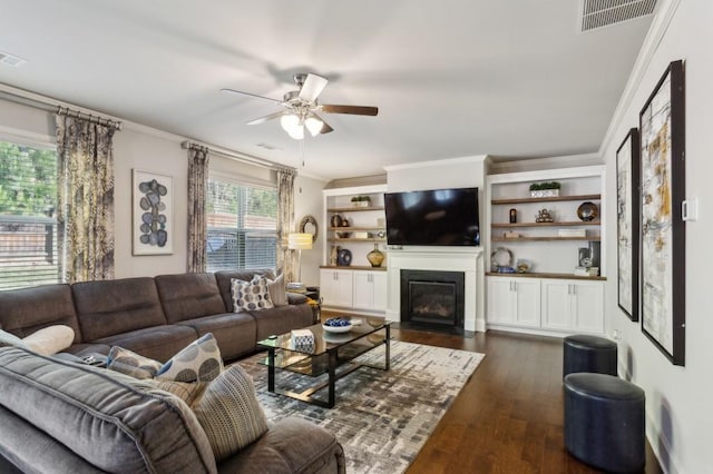 6977 Demeter Dr, Atlanta, GA 30349 - living room featuring ornamental molding, ceiling fan, dark wood finished floors, and a fireplace with flush hearth