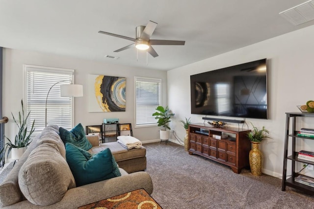 6977 Demeter Dr, Atlanta, GA 30349 - carpeted living room featuring ceiling fan, baseboards, and healthy amount of natural light