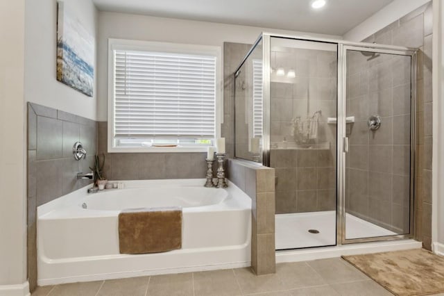 6977 Demeter Dr, Atlanta, GA 30349 - full bath with a shower stall, tile patterned flooring, and a garden tub