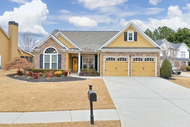 craftsman house featuring a garage, roof with shingles, and driveway