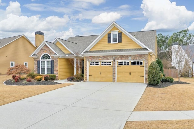 view of front of house with driveway and a shingled roof