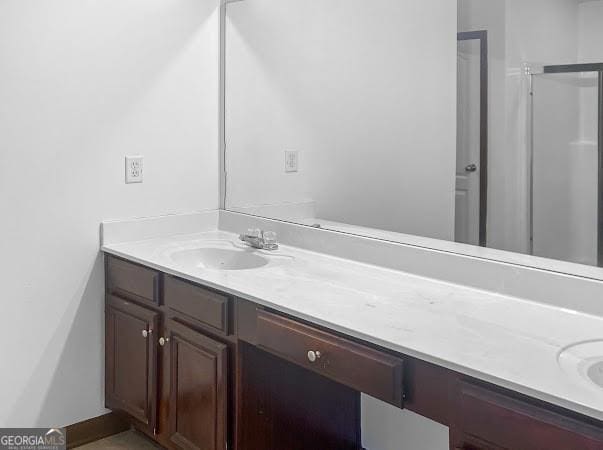 bathroom with vanity and baseboards