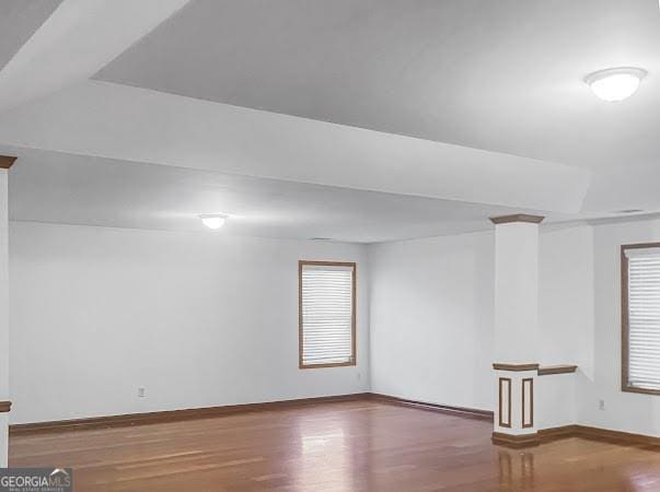 interior space with wood finished floors and baseboards