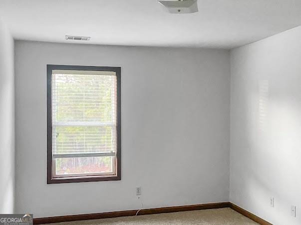 empty room with baseboards and visible vents