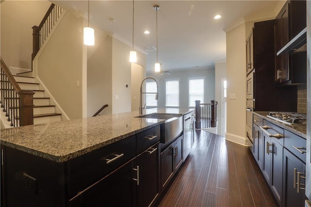 1949 Townsend Ct NE Unit 22, Atlanta, GA 30329 - kitchen featuring stainless steel appliances, a sink, an island with sink, baseboards, and dark stone countertops