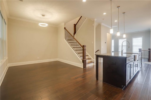 1949 Townsend Ct NE Unit 22, Atlanta, GA 30329 - kitchen featuring a sink, baseboards, dark wood finished floors, ornamental molding, and a center island with sink