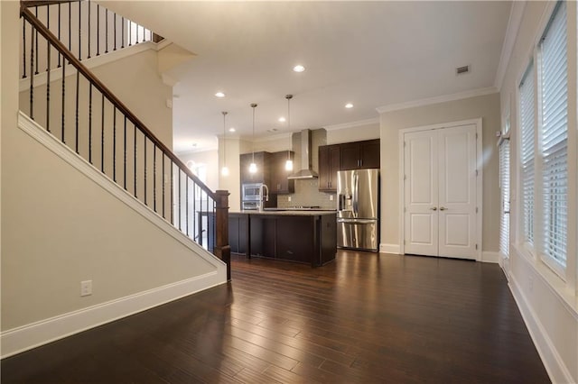 1949 Townsend Ct NE Unit 22, Atlanta, GA 30329 - kitchen with appliances with stainless steel finishes, wall chimney range hood, dark brown cabinetry, crown molding, and light countertops