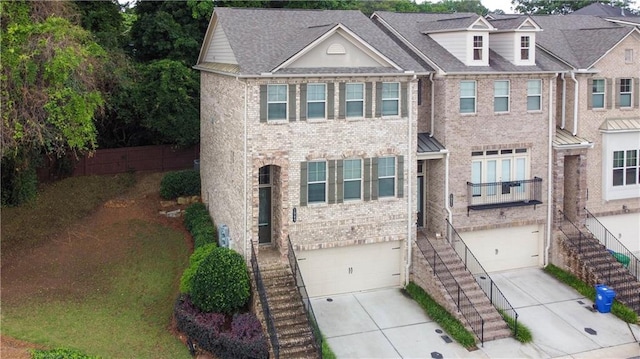 1949 Townsend Ct NE Unit 22, Atlanta, GA 30329 - view of property with driveway, brick siding, a garage, and stairs