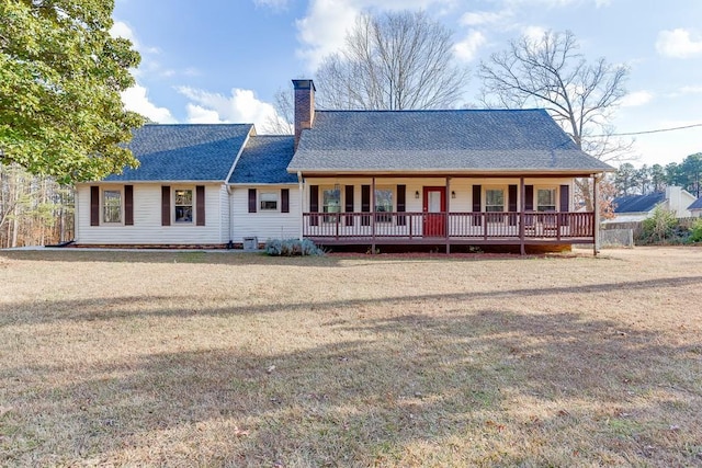 view of front of property with a front yard and central AC