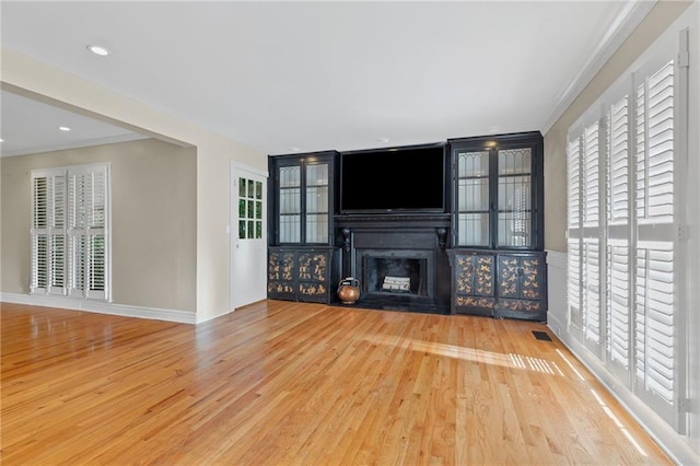 3231 Connemara Trce, Lawrenceville, GA 30044 - unfurnished living room featuring a fireplace, wood finished floors, ornamental molding, and baseboards