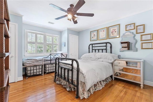 3231 Connemara Trce, Lawrenceville, GA 30044 - bedroom with ornamental molding, wood finished floors, baseboards, ceiling fan, and a closet
