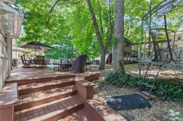3231 Connemara Trce, Lawrenceville, GA 30044 - view of yard featuring outdoor dining area and a trampoline