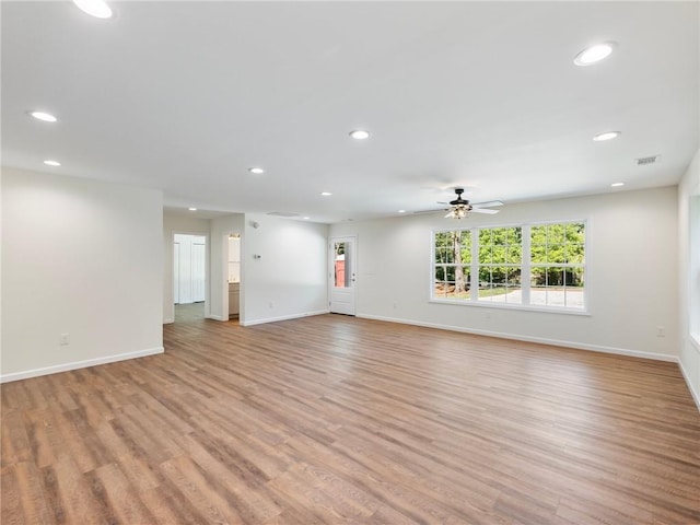 unfurnished living room with light wood-style floors, visible vents, and recessed lighting