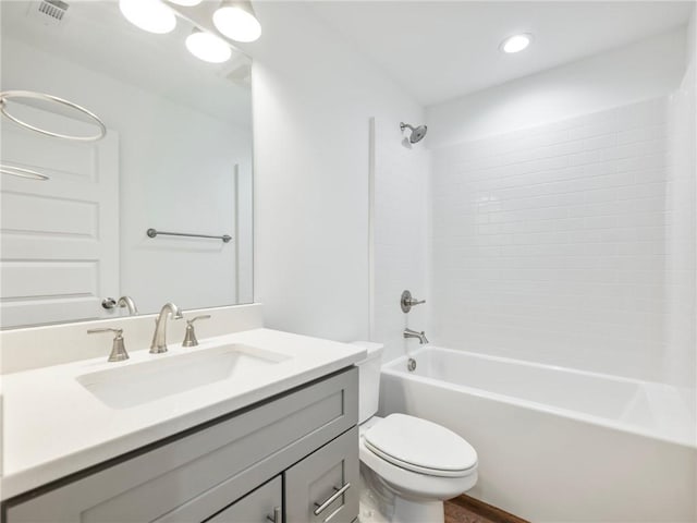 bathroom featuring shower / washtub combination, visible vents, vanity, and toilet