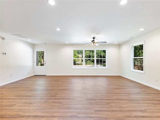 spare room featuring light wood-style floors, a wealth of natural light, and recessed lighting