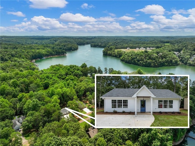 aerial view with a forest view and a water view