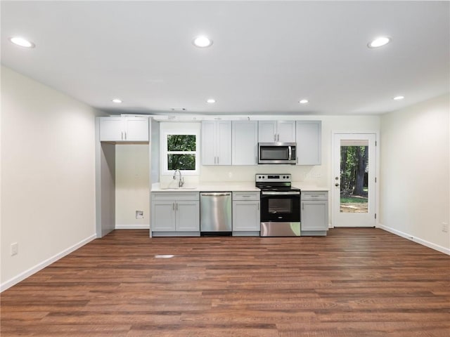 kitchen with stainless steel appliances, recessed lighting, and dark wood finished floors