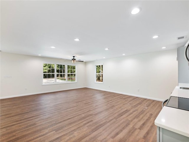 unfurnished living room featuring light wood-style floors, recessed lighting, visible vents, and baseboards