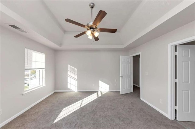 116 Rolling Meadows Ct, Hampton, GA 30228 - unfurnished bedroom with ceiling fan, carpet floors, and a tray ceiling