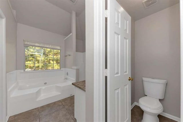 116 Rolling Meadows Ct, Hampton, GA 30228 - bathroom featuring tile patterned floors, vanity, a tub to relax in, and toilet