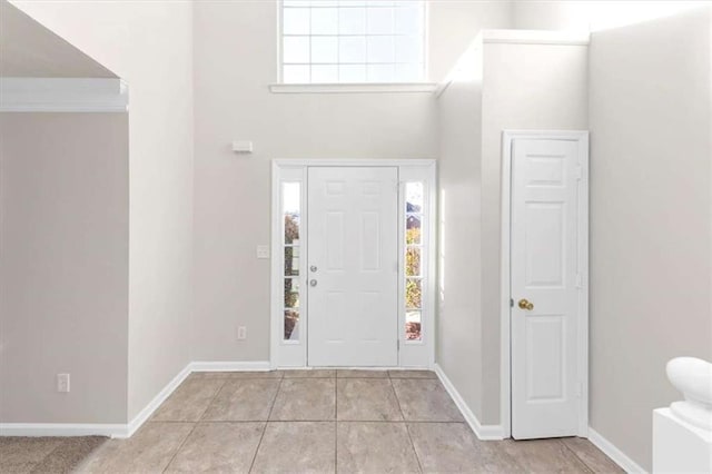 116 Rolling Meadows Ct, Hampton, GA 30228 - foyer entrance with light tile patterned floors and a towering ceiling