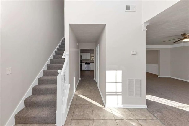 116 Rolling Meadows Ct, Hampton, GA 30228 - staircase with carpet flooring, ceiling fan, and crown molding