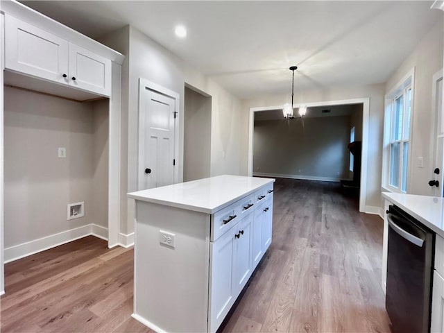 kitchen with pendant lighting, a center island, black dishwasher, and white cabinets