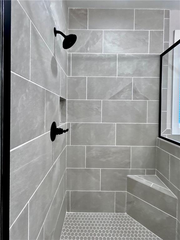 bathroom with a tile shower