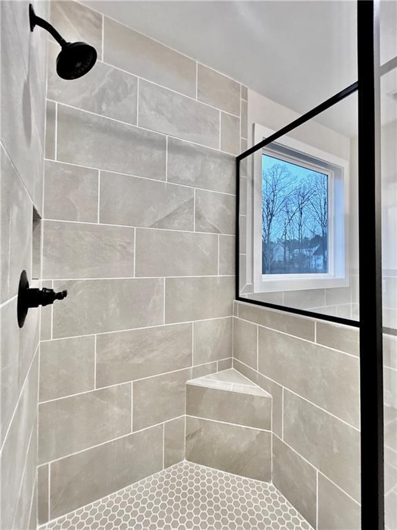 bathroom with tiled shower