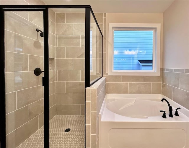 bathroom featuring shower with separate bathtub