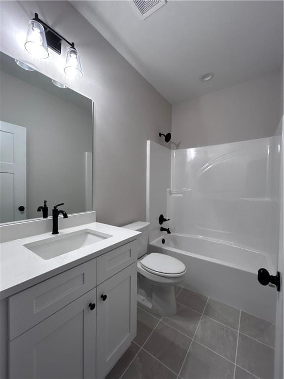 full bathroom featuring vanity, tile patterned floors, toilet, and washtub / shower combination