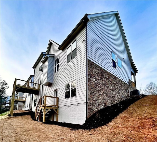 view of side of property with central AC unit