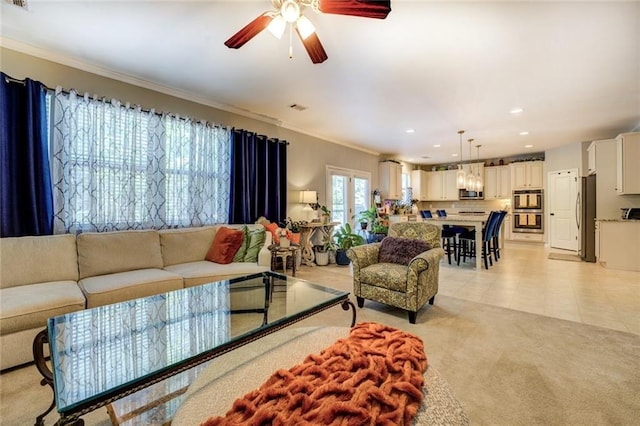 345 Piedmont Cir, Covington, GA 30016 - living room featuring a ceiling fan, ornamental molding, recessed lighting, light tile patterned floors, and light carpet
