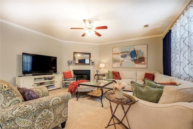 345 Piedmont Cir, Covington, GA 30016 - living area with crown molding, ceiling fan, a glass covered fireplace, and carpet floors