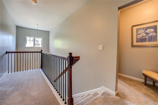 345 Piedmont Cir, Covington, GA 30016 - staircase featuring carpet flooring, baseboards, and a chandelier