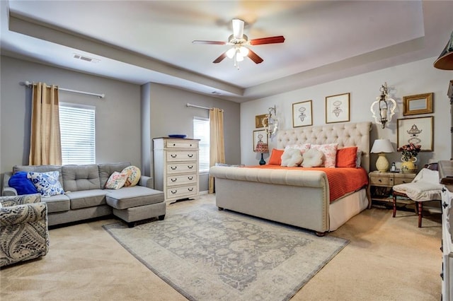 345 Piedmont Cir, Covington, GA 30016 - bedroom with light carpet, a tray ceiling, and ceiling fan