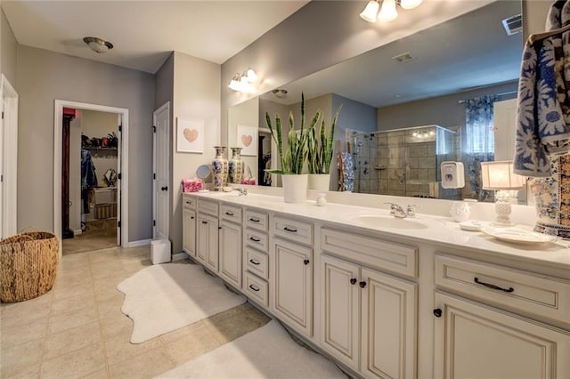 345 Piedmont Cir, Covington, GA 30016 - bathroom with a shower stall, double vanity, tile patterned floors, and a spacious closet