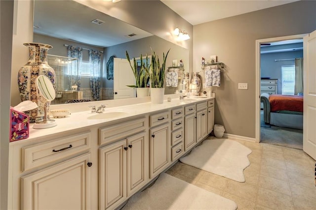 345 Piedmont Cir, Covington, GA 30016 - bathroom featuring double vanity, healthy amount of natural light, ensuite bath, and baseboards