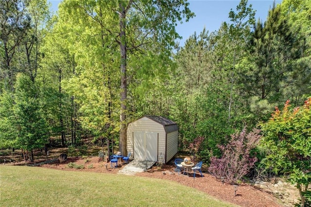 345 Piedmont Cir, Covington, GA 30016 - view of grassy yard featuring a shed, an outdoor structure, and a view of trees