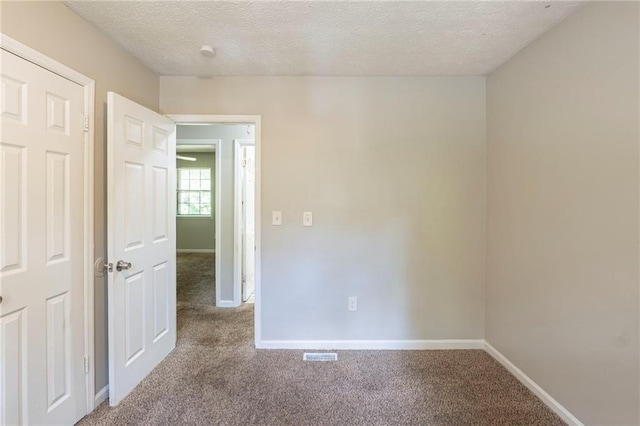 2242 Cherokee Valley Cir, Lithonia, GA 30058 - carpeted empty room with a textured ceiling and baseboards