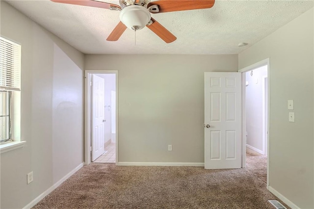 2242 Cherokee Valley Cir, Lithonia, GA 30058 - unfurnished bedroom with carpet flooring, a textured ceiling, a ceiling fan, and ensuite bathroom