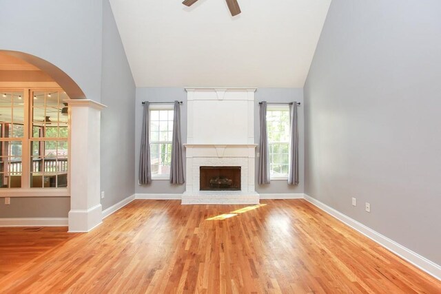 unfurnished living room featuring light hardwood / wood-style flooring, a wealth of natural light, and ceiling fan