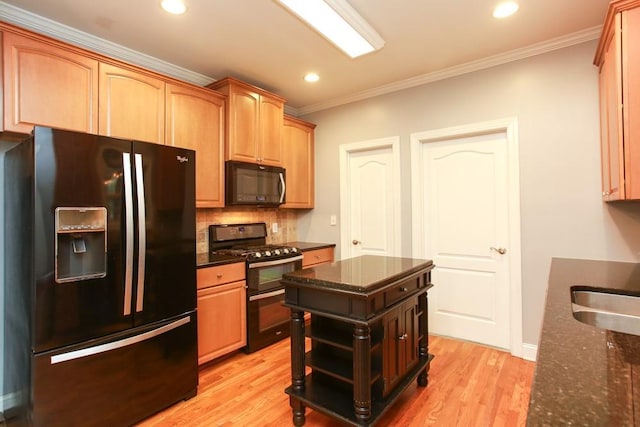 kitchen featuring crown molding, dark stone countertops, tasteful backsplash, black appliances, and light wood-type flooring