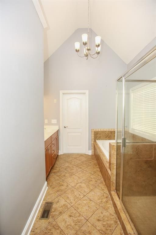 bathroom with vanity, a notable chandelier, vaulted ceiling, and separate shower and tub