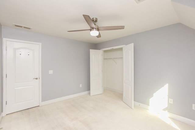 unfurnished bedroom with lofted ceiling, ceiling fan, and a closet