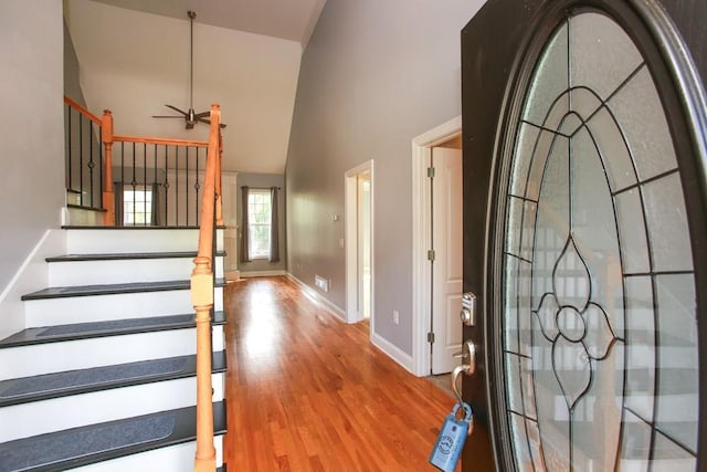 foyer featuring hardwood / wood-style flooring, ceiling fan, and high vaulted ceiling